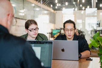 Bitlyft employees working and looking at a computer