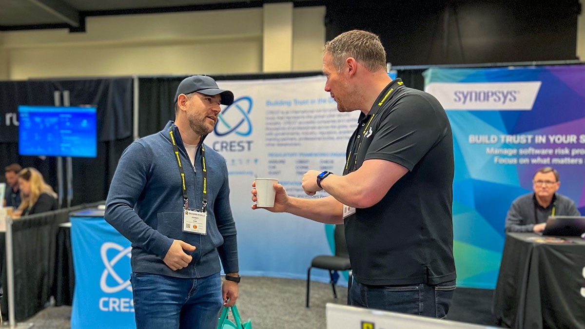 BitLyft CEO talks with conference attendee