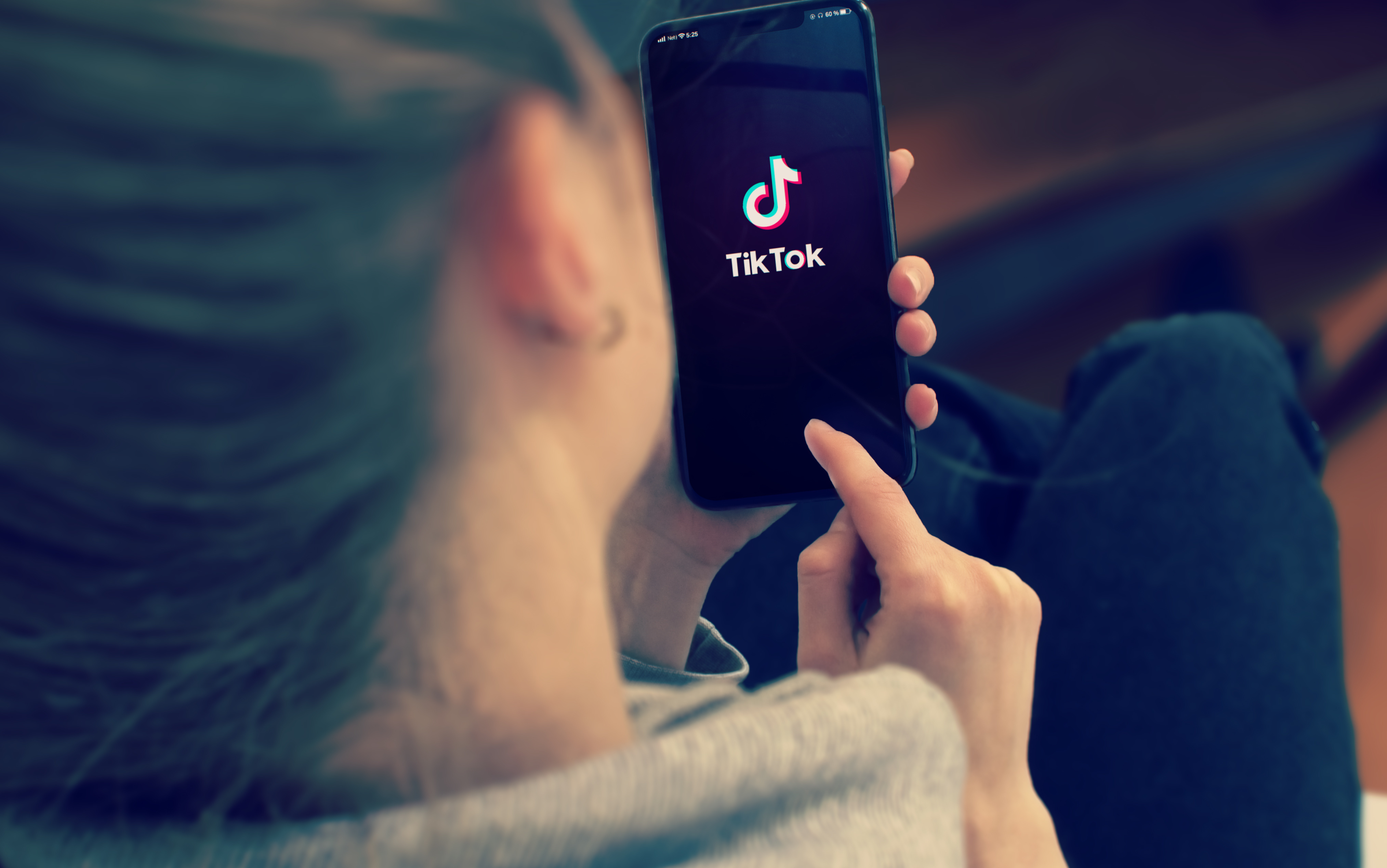woman looking at tiktok on her phone