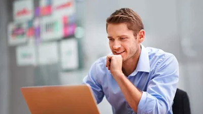 Man-working-on-laptop-comparing-SIEM-tools Man-working-on-laptop-comparing-SIEM-tools